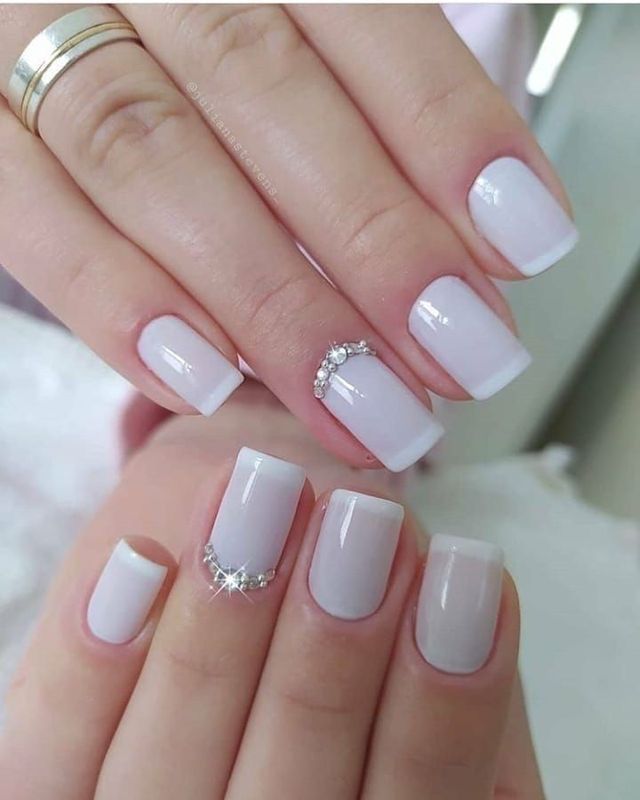 White nails with gemstones